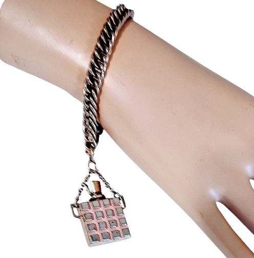 1950s_perfume_pendant_metal_charm_bracelet_vintage-removebg-preview.png