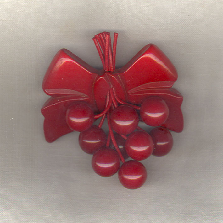 Bakelite Cherries Bow Brooch Repaired.jpg