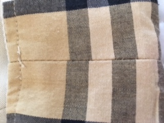 Is this vintage Burberry authentic? I understand they used Burberrys back  then but what's throwing me off is the stitching on the left side of the tag  is a little crooked. 
